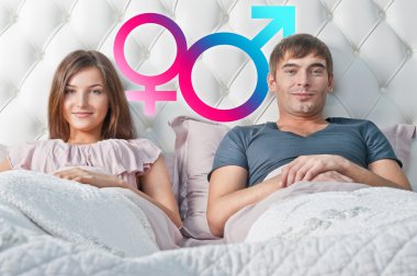 Young couple lying in their bed thinking about something. Gender clipart