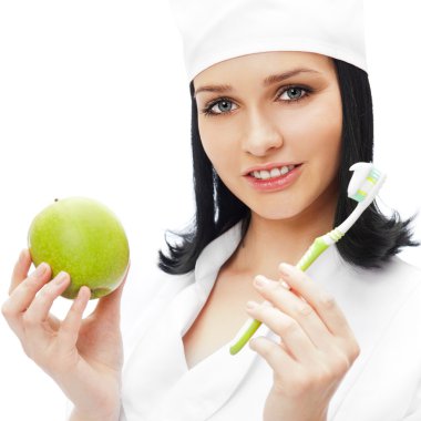 Beautiful young female dentist doctor with a toothbrush and gree clipart