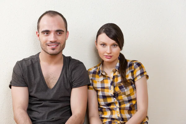 Atraente jovem adulto casal sentado perto no chão em casa smi — Fotografia de Stock