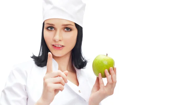 Beyaz izole bir yeşil elma tutan kadın tıp doktoru — Stok fotoğraf