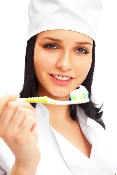 Beyaz arka plan üzerinde izole bir diş fırçası tutan diş hekimi — Stok fotoğraf