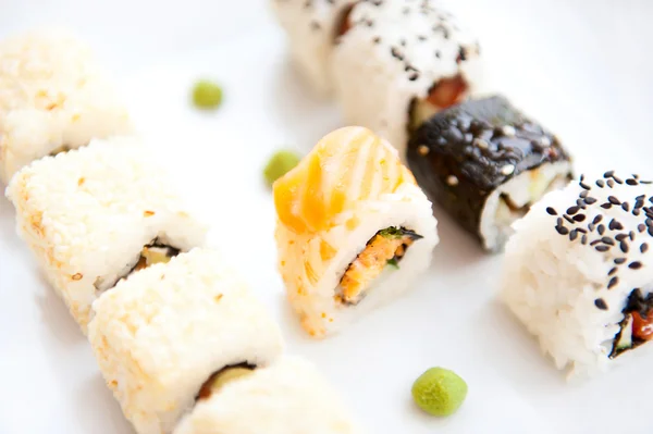 Sushi rolls on white plate — Stock Photo, Image