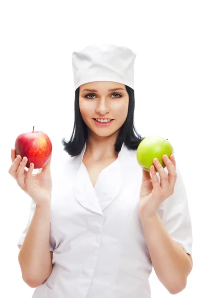 A female medical doctor holding a red and green apples in differ Royalty Free Stock Photos