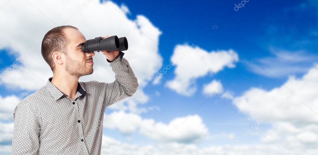 Business man with binoculars looking to the future or looking fo