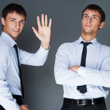 Closeup of a young smiling business man standing in three differ clipart