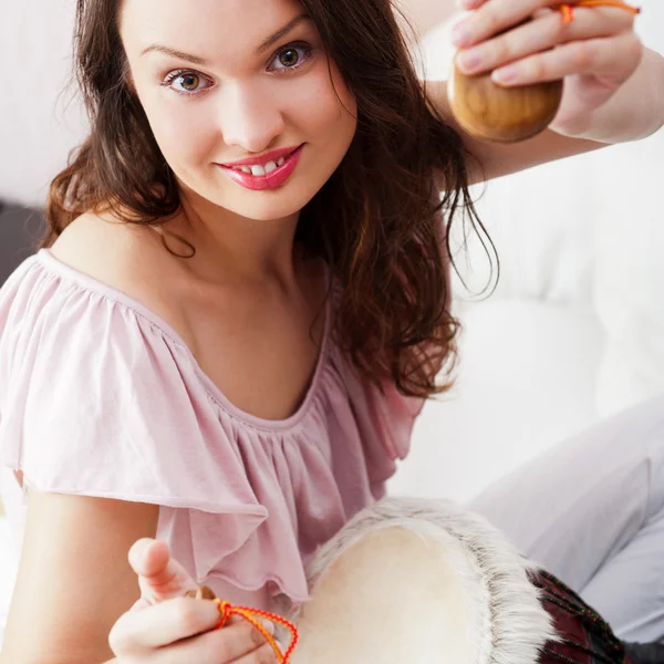 Happy young pretty woman at home, smiling and playing arabic tra — Stock Photo, Image