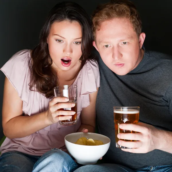 A couple watching a scary movie and it scared them so much that — Stock Photo, Image