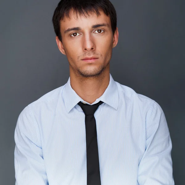 Portrait of young business man on a desk — Stock Photo, Image