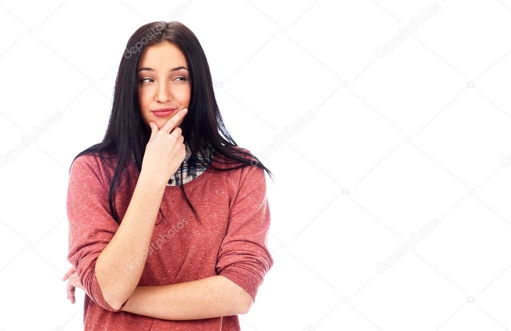 Beautiful young woman daydreaming over white background with finger on chin