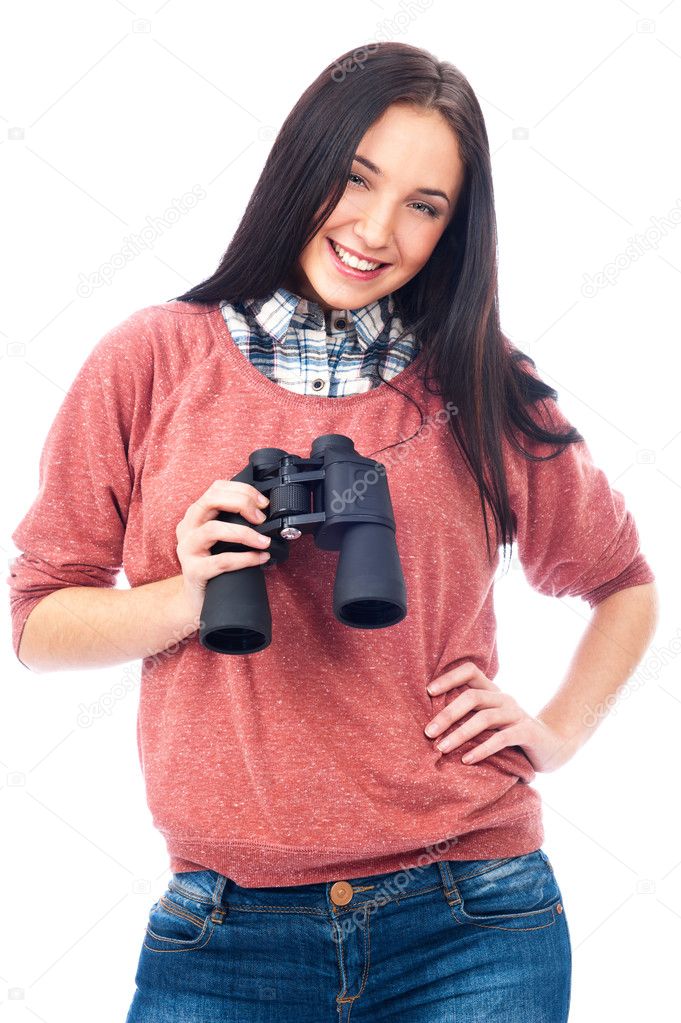 Happy young woman looking at camera and holding binoculars. Isolated on whi
