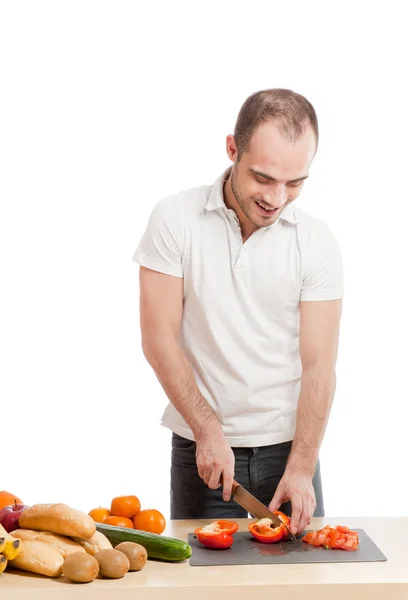 Adult smiling man cooking in the kitchen — Stock Photo, Image