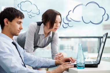 A business team of two colleagues planning work in office. Blank cloud balloons of their dialog for your text and logo clipart