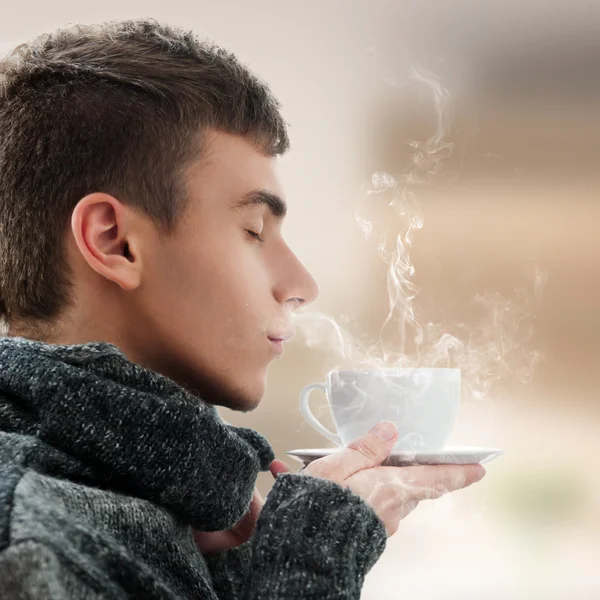 Close-up portrait of young man enjoying hot beverage at home — Stock Photo, Image