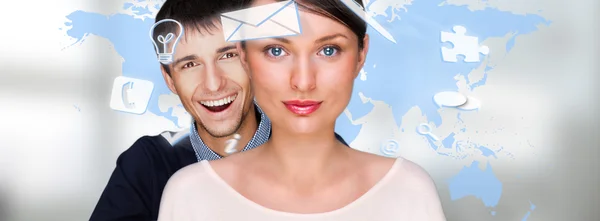 Portrait of young man and woman looking at camera with map on background against white background. Symbols of daily affairs flying around them — Stock Photo, Image