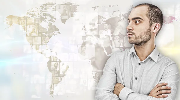 Portrait of young businessman. Standing against world map with photo of . International business communications concept — Stock Photo, Image