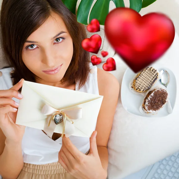 Young pretty attractive smiling woman with heart lying relaxed at her home on sofa. Top View — Stock Photo, Image