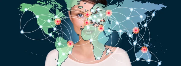 Attractive brunette young woman in futuristic interface standing in front of world map with glowing hot points location and connection lines — Stock Photo, Image