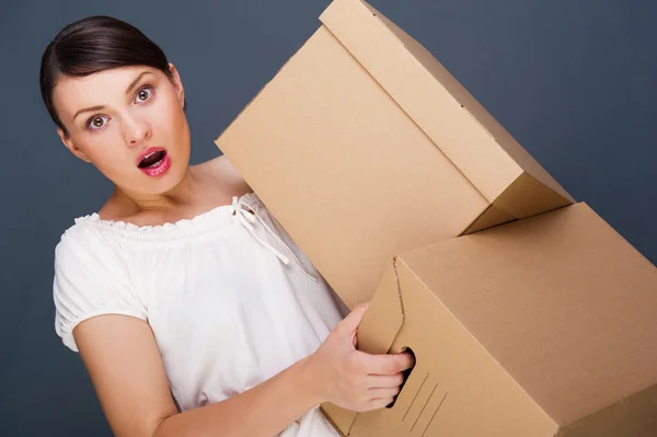 Close-up portrait of a young woman with boxes — Stock Photo, Image