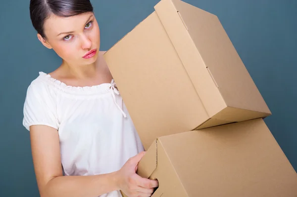 Close-up portrait of a young woman with boxes — Stock Photo, Image