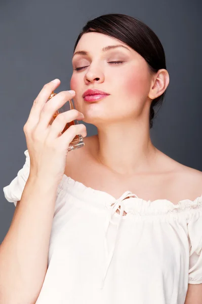 Portret van mooi en sexy vrouw met parfumfles — Stockfoto