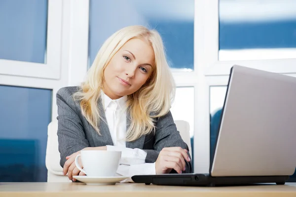 Portrait of businesswoman working on laptop at her office — Stock Photo, Image