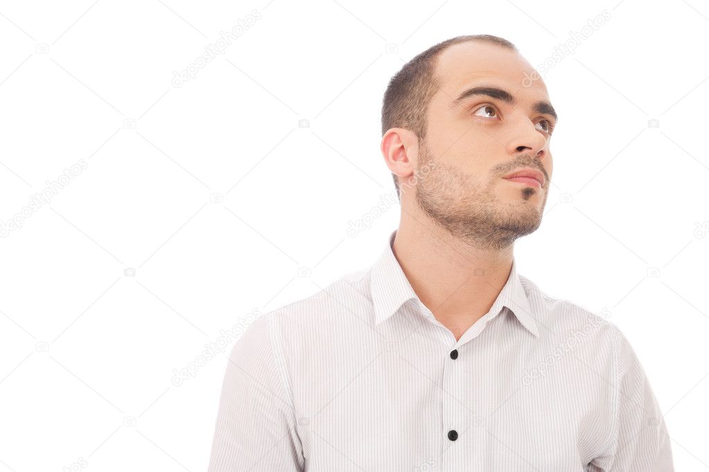 Thinking man isolated on white background. Close-up portrait of a casual young pensive businessman looking up. Caucasian male model