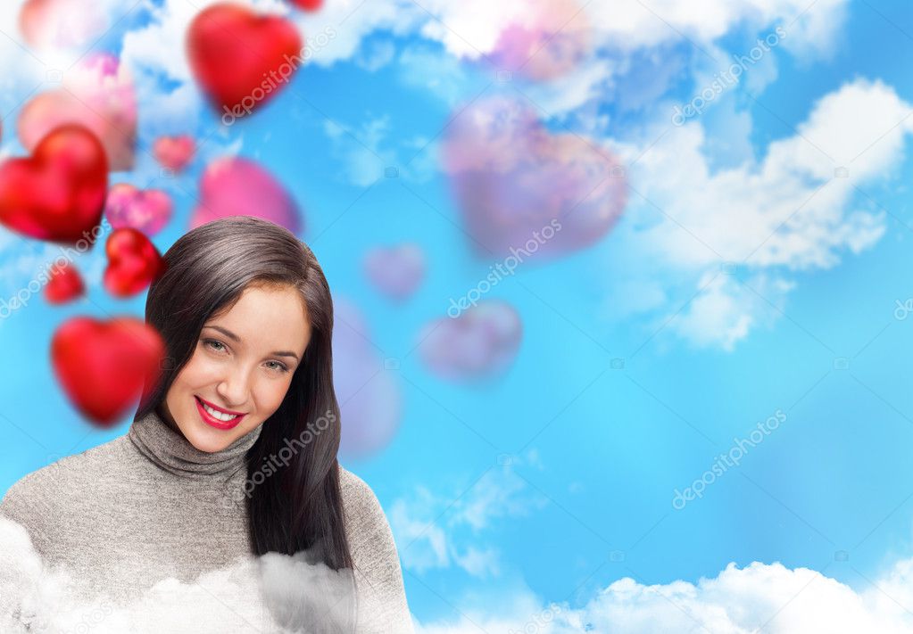 Happy young adult woman with red heart on romantic background with sky and clouds, laughing