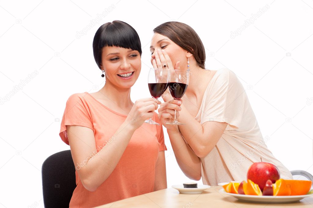 Cheerful Women eating sushi rolls and drinking red wine