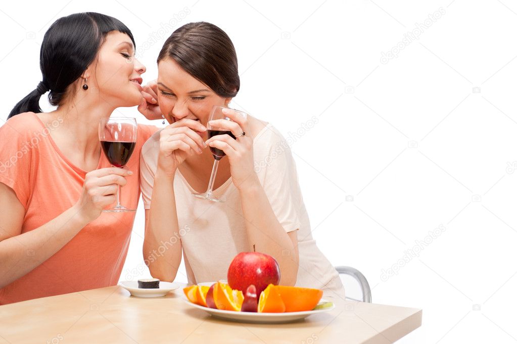 Cheerful Women eating fruits and drinking red wine