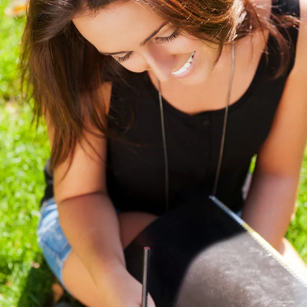 A shot of an caucasian student studying on campus lawn — Stock Photo, Image