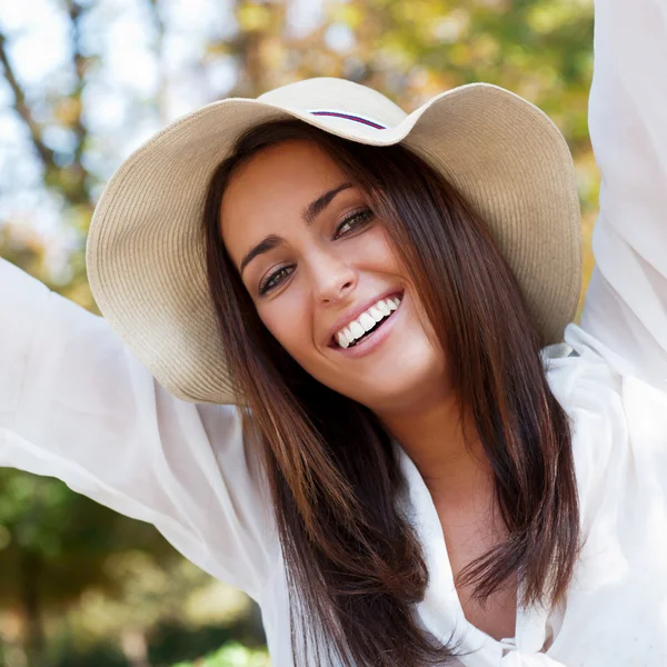 Portrait of sweet young woman enjoying at the park with raised h — Stock Photo, Image