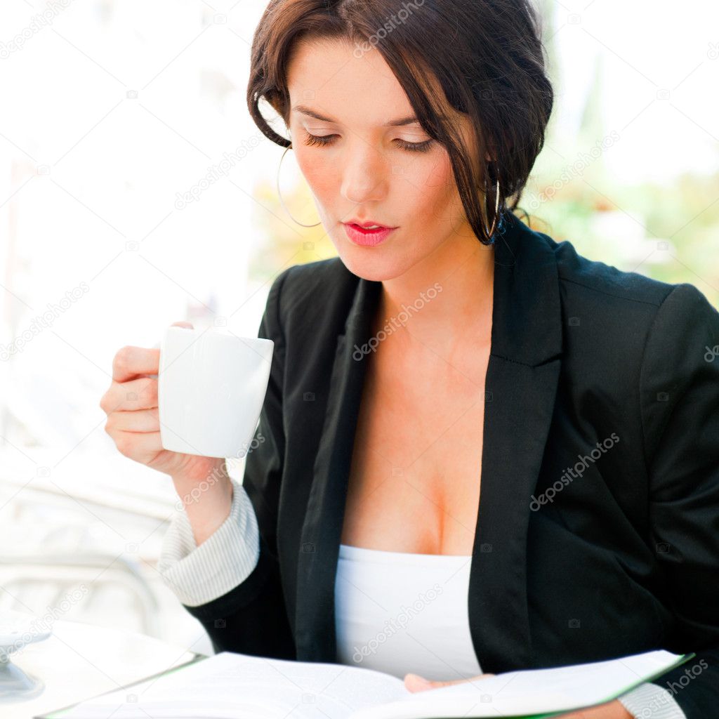 Portrait of a young attractive business woman sitting at outdoor