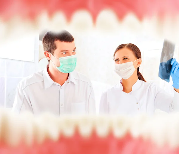 A dentist and a nurse preparing to cure patient. — Stock Photo, Image