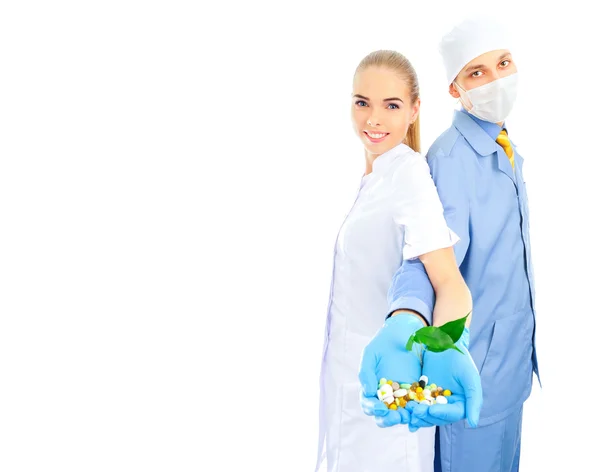 Portrait of two doctors co-workers standing together hand in hand — Stock Photo, Image