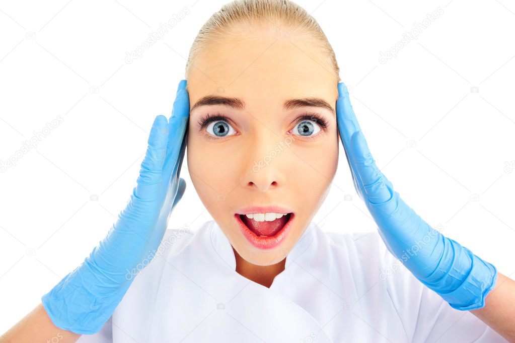 Confused young female doctor on white background