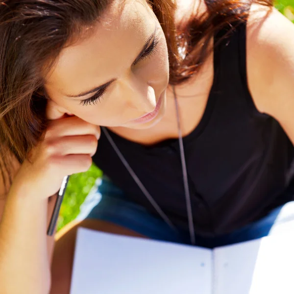 A shot of an caucasian student studying on campus lawn — Stock Photo, Image