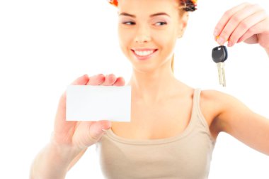 Happy woman wearing protective helmet holding new key and blank white card clipart