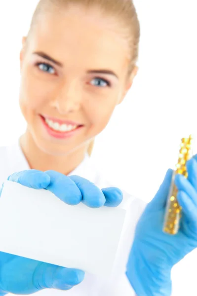 Portrait of a doctor holding business card and medicine — Stock Photo, Image