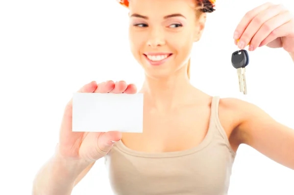 Happy woman wearing protective helmet holding new key and blank white card — Stock Photo, Image