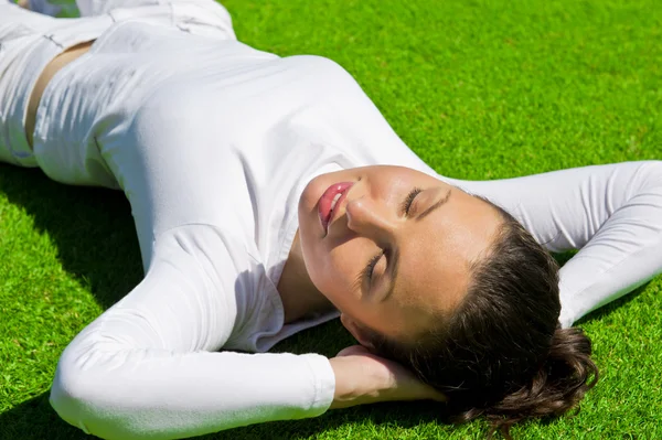Женщина расслабляется на открытом воздухе выглядит счастливым и беззаботным — стоковое фото
