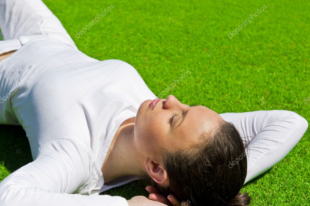 Woman relaxing outdoors looking happy and carefree