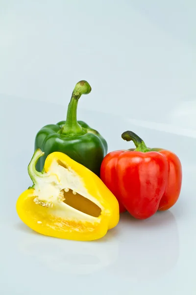 Green, Red and Cut Yellow Capsicums — Stock Photo, Image