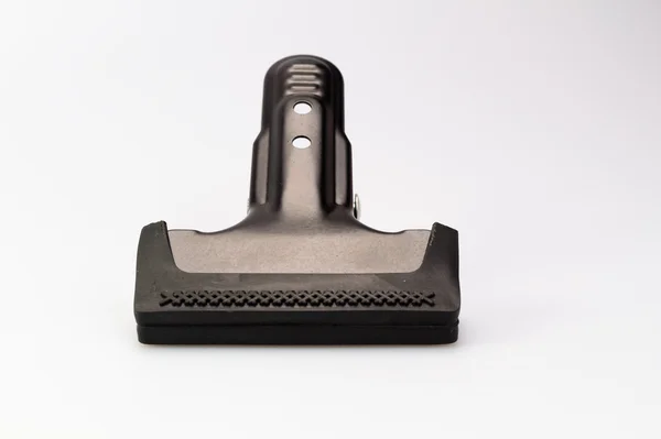 Black Clamp on white surface — Stock Photo, Image