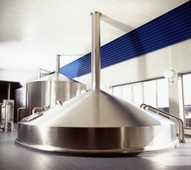 Brewery workshop with stainless fermentation vats clipart