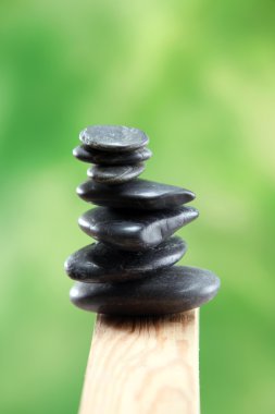 Zen. Stack of stone on the green color background clipart