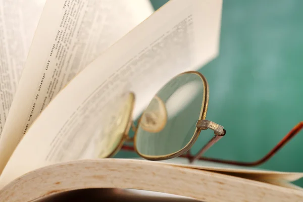 stock image Open page at glasses resting on the book