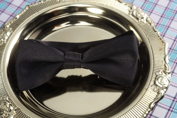 Bowtie rest on the golden tray — Stock Photo, Image