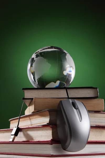 Glass globe on top of stack of book — Stock Photo, Image