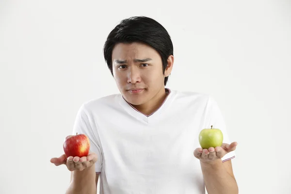 Homem segurando uma maçã verde e maçã vermelha — Fotografia de Stock