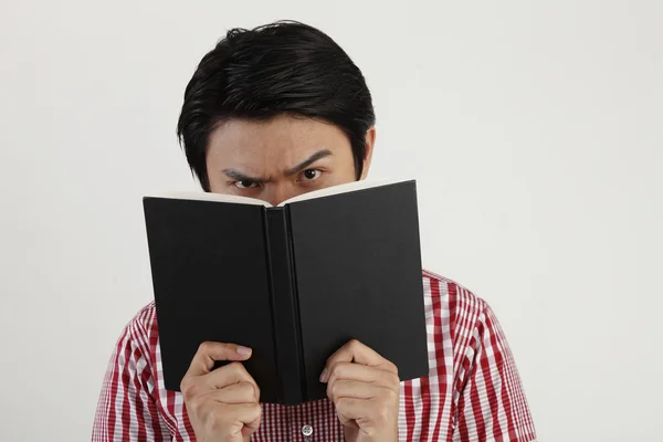 :studio shot of Man holding open book — Stock Photo, Image